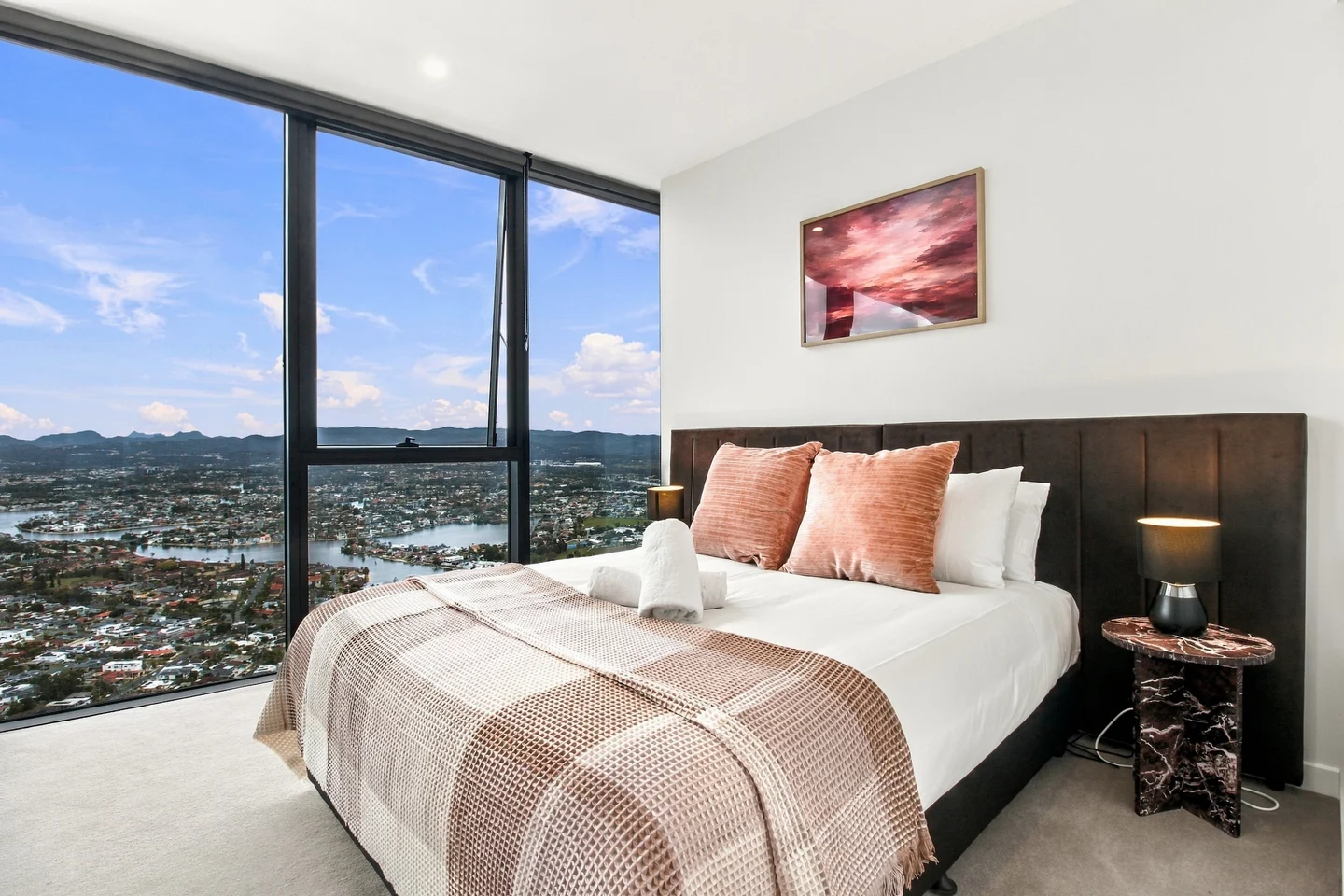 Original photograph of the completed bedroom with peach cushions and river views